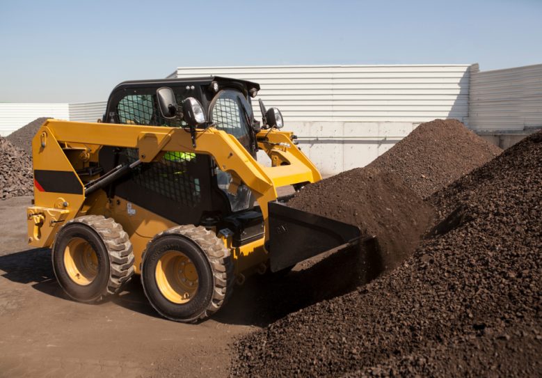 Skid Loader or Bobcat Working On Manganese In Bulk — Hire Pro In Mudgeeraba, QLD