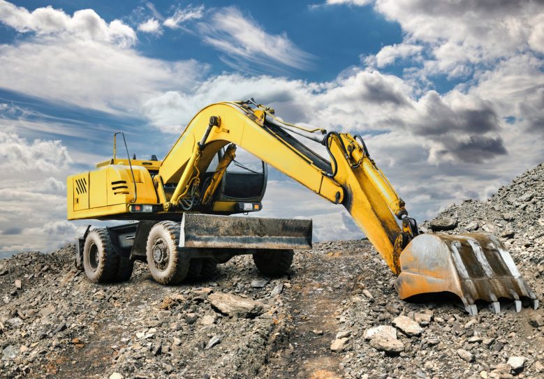Large Yellow Crawler Excavator Moving Stone Or Soil — Hire Pro In Mudgeeraba, QLD