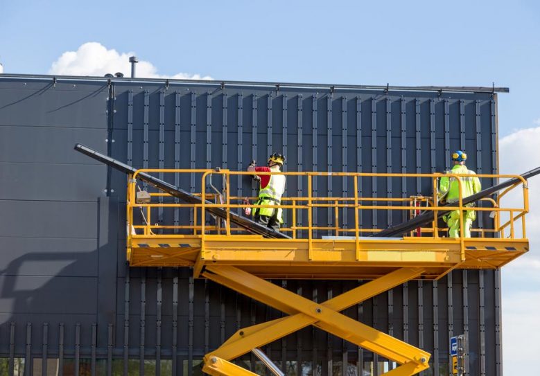 Yellow Scissor Lift Platform For Elevated Work — Hire Pro In Mudgeeraba, QLD